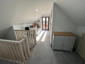 a hallway with stairs and a stair case at 32 Cherry-Lodge-Tranquil-Hot Tub-Fishing Lake-7m to beach in Garton