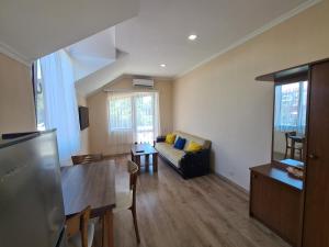 a living room with a couch and a table at Guest House Rustaveli in K'obulet'i