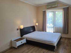 a bedroom with a large bed and a window at Guest House Rustaveli in K'obulet'i