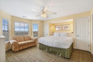 a bedroom with a bed and a chair and a ceiling fan at Large 2 Bed Condo w Beautiful Deck Views-Free Attraction Tickets-Table Rock Lake Access in Kimberling City +53 photos