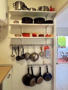 a kitchen with pots and pans and utensils at Apartament Sant Feliu de Guíxols downtown in Sant Feliu de Guixols +22 photos