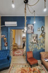 a living room with blue walls and a blue couch at Creative retreat and Artist Haven Bohemian Villa on Calea Victoriei in Bucharest