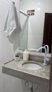 a bathroom counter with a sink and a mirror at CASA DE PRAIA CAJUEIRO ALTER in Alter do Chao