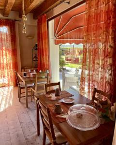 a dining room with tables and chairs and a large window at Country Home B&B Il Melo in Vicenza +43 photos