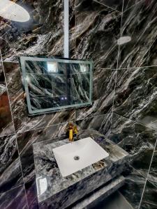 a bathroom with a sink and a mirror at Sun & Moon Homestay in Port Dickson +10 photos