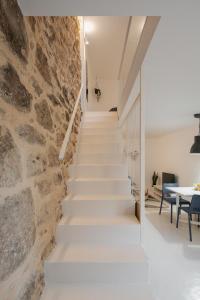 a staircase leading up to a room with a stone wall at Casa Dorado in Pontevedra