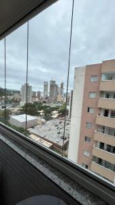 a view from a window of a parking lot at Apartamento Vista Mar - Área de Lazer - Poucos Minutos do Mar in Itapema