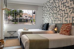 Postel nebo postele na pokoji v ubytování Nomadia Coliving Boutique + 37 fotografií