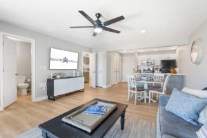 a living room with a couch and a ceiling fan at Table Rock Shoreline Steps Away, Newly Renovated Condo, $400 of Daily Free Tickets in Kimberling City
