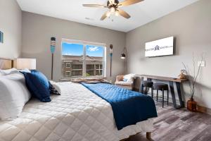 a bedroom with a bed and a desk and a window at New Log Cabin, Free Local Attraction Tickets Daily, Ozark Views, Cmty Amenities! in Branson +55 photos
