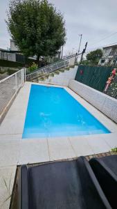 a large blue swimming pool next to some stairs at LUSANYUN 1 in Villa Independencia +5 photos