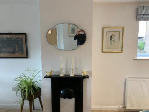 a room with a fireplace and a mirror on the wall at Island town Apartment in Enniskillen +9 photos