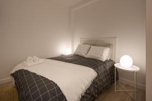 a bedroom with a bed with two lamps on it at Casa Dorado in Pontevedra +6 photos