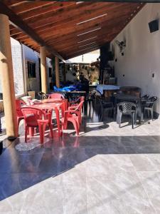 a group of tables and chairs in a restaurant at Casa de festa para festa do peao de barretos in Barretos