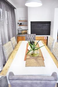 a dining room with a table and chairs at 4on Pebbles Holiday Home in Swakopmund
