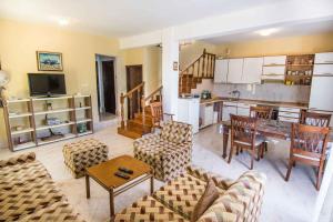 a living room with a couch and chairs and a kitchen at Holiday home in Tkon - Insel Pasman 6922 in Tkon