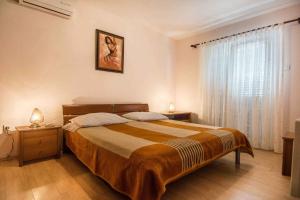 a bedroom with a large bed and a window at Holiday home in Tkon - Insel Pasman 6922 in Tkon