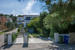 a house with a gate in front of a street at Holiday home in Tkon - Insel Pasman 6922 in Tkon