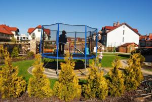 a person on a trampoline in a park at Villa Aida in Mielno