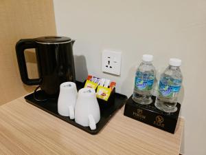 two bottles of water sitting on top of a counter at Forum Hotel Penang in George Town