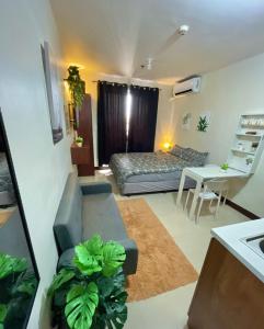 a small living room with a bed and a couch at Cel Escapia in Lapu Lapu City