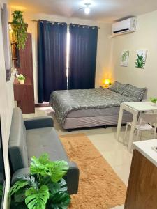 a living room with a bed and a couch at Cel Escapia in Lapu Lapu City
