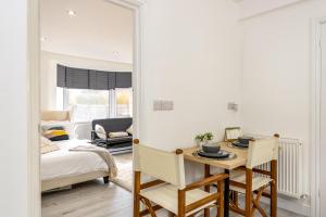 a bedroom with a bed and a table and chairs at Luxury Studio with Free Parking in Nottingham