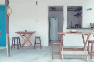 a group of tables and stools in a room at Pousada Infinito Azul in Prea +22 photos