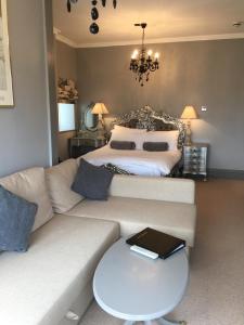 a living room with a couch and a bed at The White House Hotel in Newquay