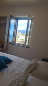 a bedroom with a bed with a large window at Tenuta Rispoli Amalfi vacationhouse in Amalfi