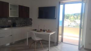 a white kitchen with a table and a window at Tenuta Rispoli Amalfi vacationhouse in Amalfi