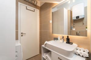 a bathroom with a white sink and a mirror at Boutique Apartment Ana in Dubrovnik +19 photos