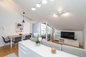 a living room with a couch and a television at Boutique Apartment Ana in Dubrovnik