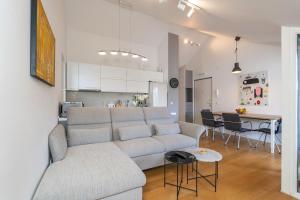 a living room and kitchen with a couch and a table at Boutique Apartment Ana in Dubrovnik