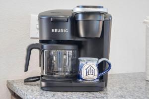 a coffee maker sitting on a counter with a cup at All New Cabin w Free Attraction Tickets-Pvt Hot Tub-Community Indoor Pool in Hollister