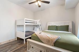 a bedroom with two beds and a ceiling fan at All New Cabin w Free Attraction Tickets-Pvt Hot Tub-Community Indoor Pool in Hollister +69 photos