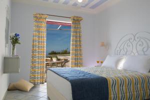 a bedroom with a bed and a balcony at Exanthia Villas in Exanthia