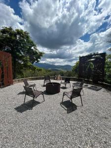 a group of chairs and a fire pit on a patio at Casa de Montanha Quinta do Alto in Aiuruoca