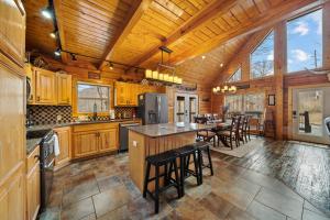 a kitchen with wooden cabinets and a bar with stools at Todd Escape in Todd