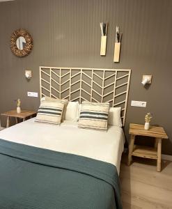 a bedroom with a large bed with two pillows at Apartamentos COVARRUBIAS in Covarrubias