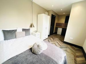 a bedroom with a large bed with a pillow on it at Luxury studios next to attractions in Streatham Vale