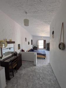 a bedroom with a bed and a desk in a room at Finca Mamaflo in Mazarrón