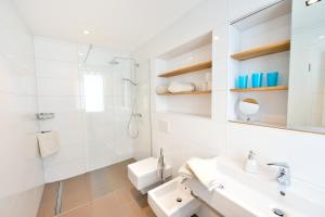 a white bathroom with a sink and a toilet at Altstadtapartment Bel Etage in Heidelberg