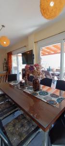a dining room table with a vase of flowers on it at Thalassa in Panayía