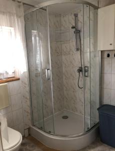 a shower stall in a bathroom with a toilet at Domek Spokojna Przystań in Przybrodzin +35 photos