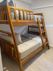 two wooden bunk beds in a room with at Beach apartment playa caracol in Chame +7 photos