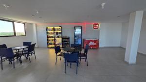 a dining room with tables and chairs in a store at Villas do Porto Residence by La Playa in Porto De Galinhas