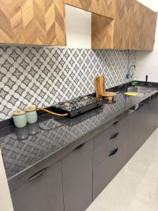 a kitchen with a counter top with a stove at Your Ultimate Edge Awaits! in Thane +25 photos