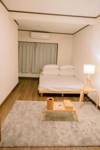 a bedroom with a bed and a coffee table at Traditional Japanese architecture heiansya in Kyoto