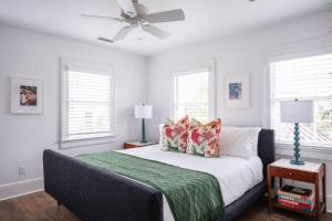 a bedroom with a bed with a ceiling fan at The Aviary at CasaZoe in Charleston
